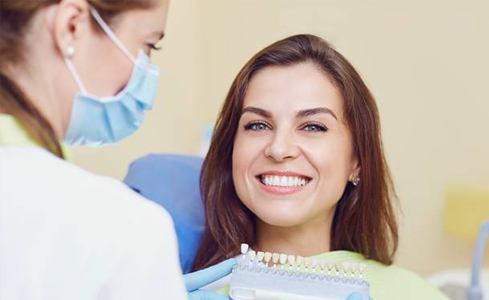 Smiling woman enjoying benefits of same day dental crowns