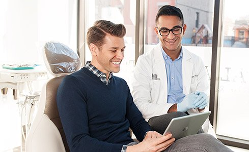 Dr. Saran and patient looking at tablet computer