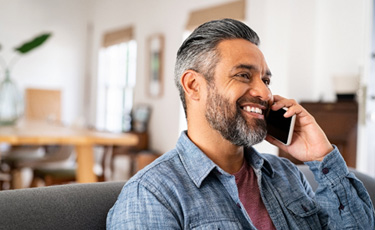 Middle-aged man smiling while on the phone