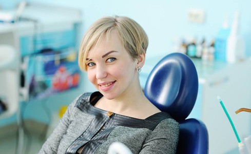 Woman smiling after dental treatment using Calaject local anesthesia