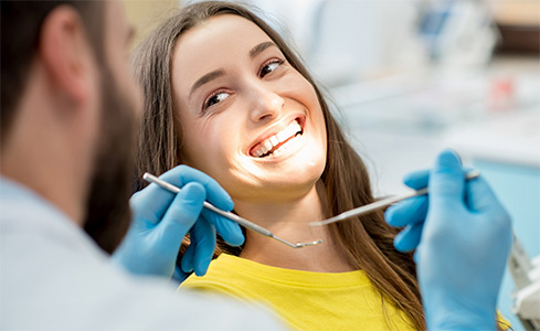 Woman smiling dentist during dental checkup