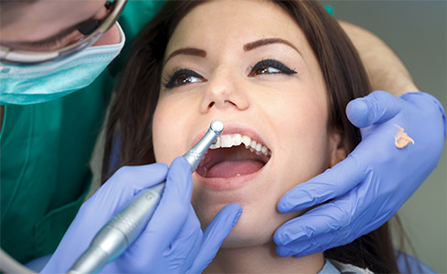Dental patient receiving teeth cleaning