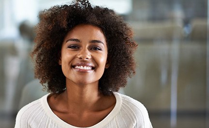 Smiling Long Island City patient reviewing cosmetic options