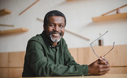 Confident Long Island City patient showing new smile