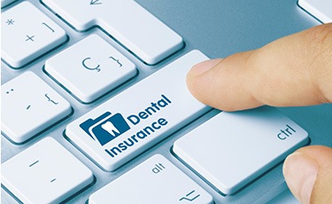 Typing on key that says “Dental Insurance”