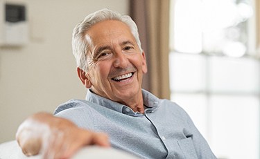 Older man smiling after getting dental implants in Long Island City