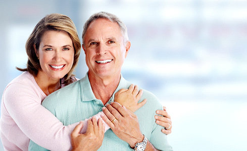 An older couple smiling and hugging each other