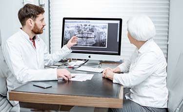 dentist showing a patient their X-rays