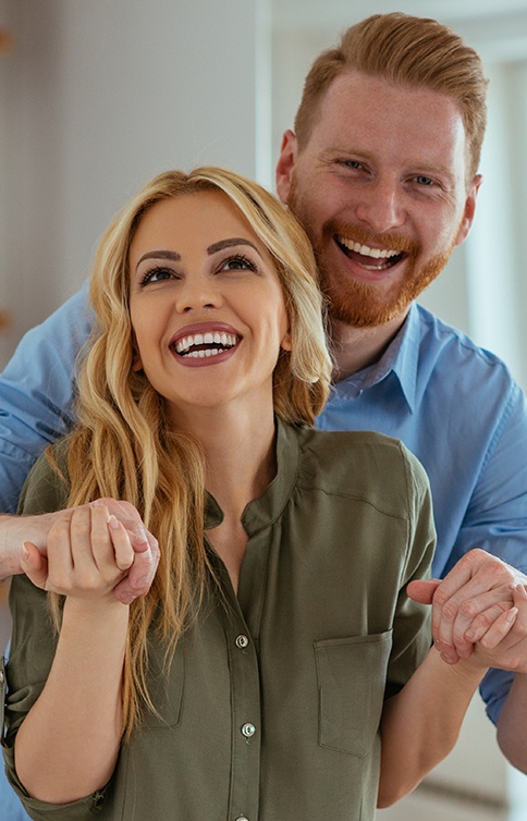 Couple with healthy smiles thanks to dental services in Long Island City