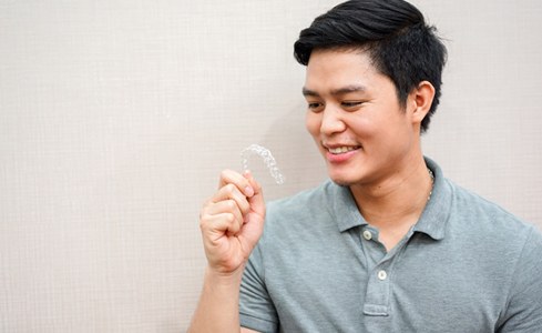 Man holding clear aligner