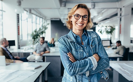 Woman smiling at work after dental treatment