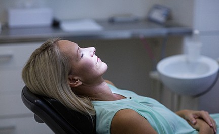 Female patient relaxed in dental chair thanks to oral conscious sedation