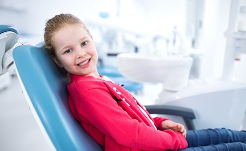 Young girl smiling in dental chair