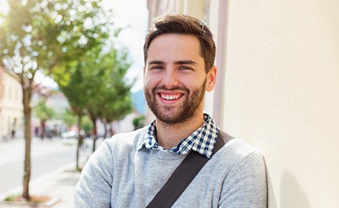 Young man with healthy smile after scaling and root planing periodontal therapy