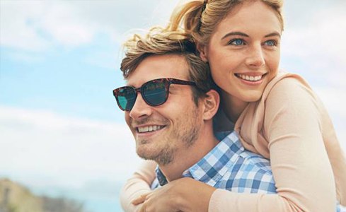 Couple smiling after same day dental restoration