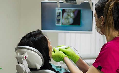 Dentist and patient looking at intraoral images