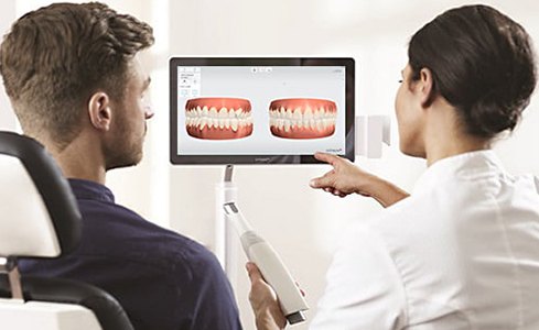 Dentist and patient looking at digital impressions