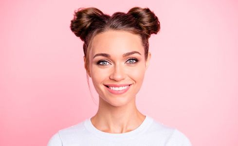 woman smiling with pink background 