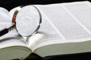 dictionary with magnifying glass