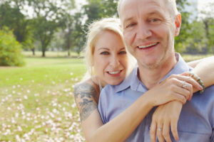 middle aged couple embracing in the park