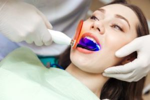 Female patient getting laser dentistry 