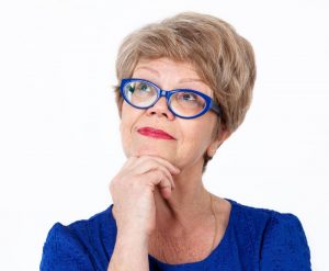 older woman smiling blue glasses