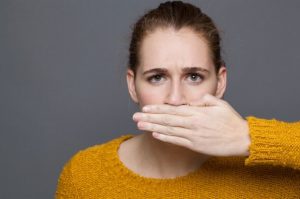 woman covering her mouth