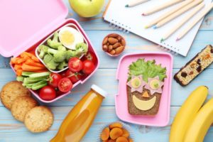 healthy snacks on a desk sitting next to a notepad and pencils