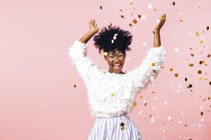 woman throws New Year’s confetti after visiting Long Island City dentist