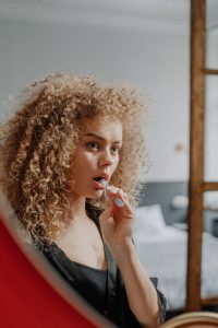 Woman brushing her teeth at dentist in Long Island City