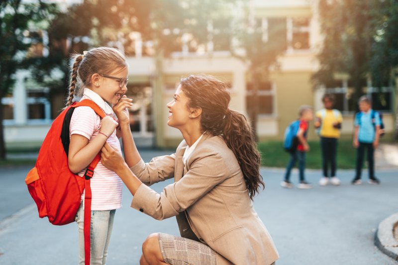 Mother dropping her child off at school