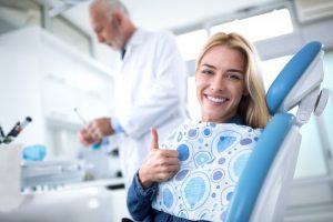 woman giving a thumbs up when visiting her dentist in Long Island City 