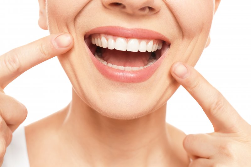 patient pointing to clean teeth