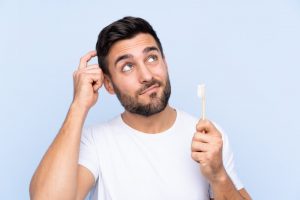 young man brushing his teeth