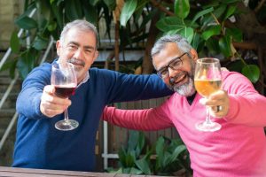  Two older men toasting with wine